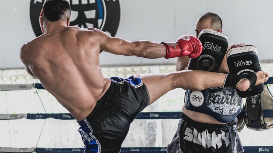 Kickboxer kicking pads hard and fast